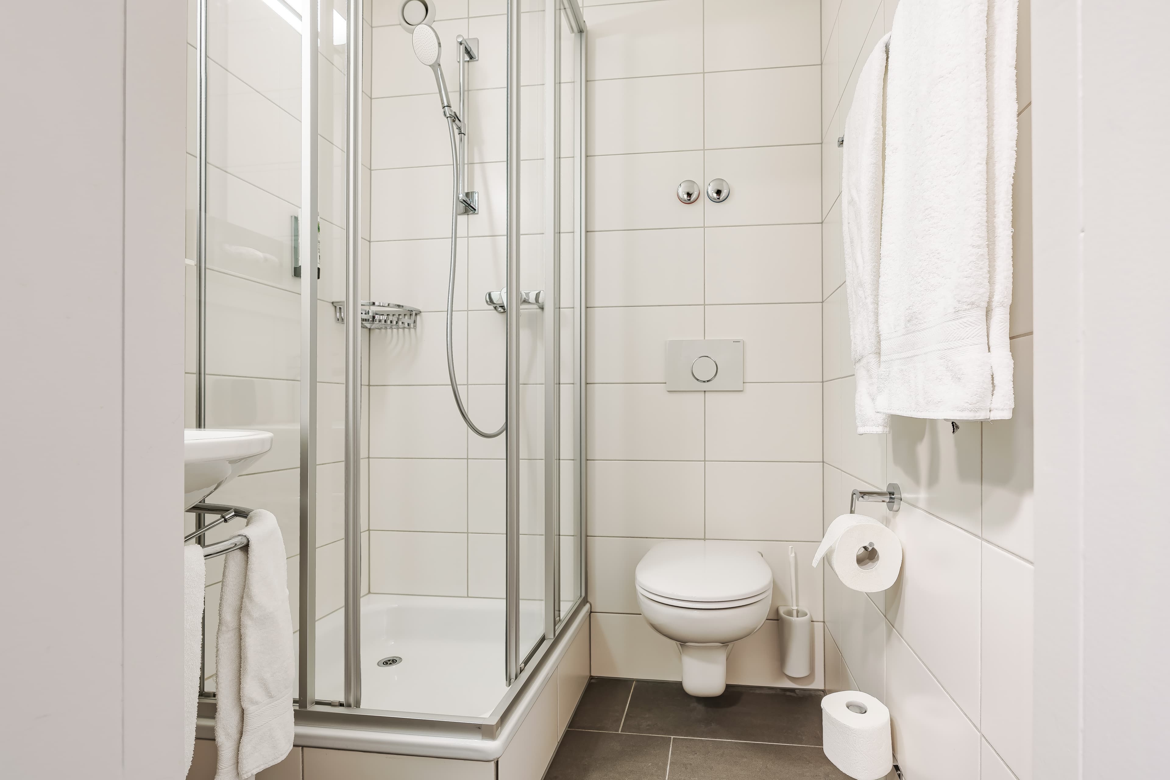 Modern bathroom in a single room at the Flex Motel Wil with shower toilet towels and toilet paper